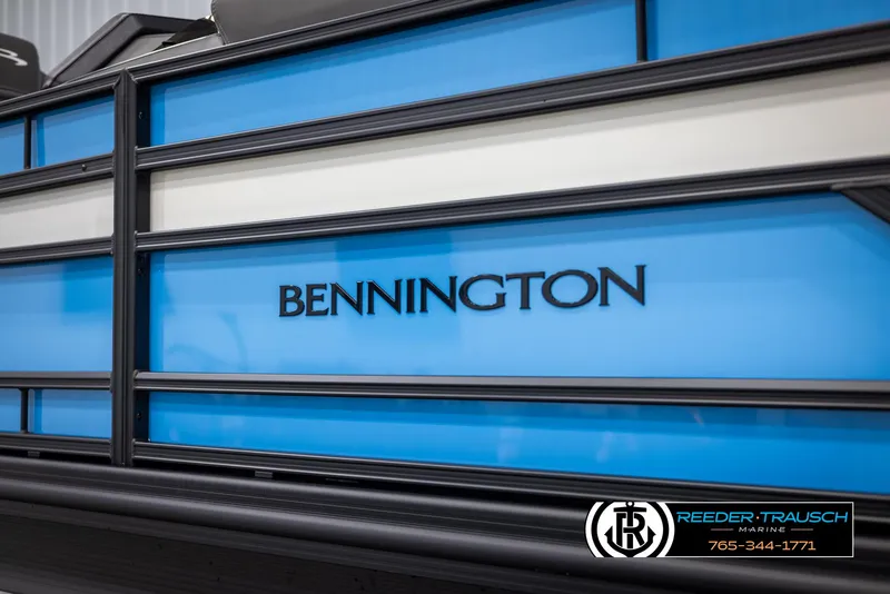 Slide: The Image of 2025 Bennington 23 SSBSE pontoon boat with blue paneling and branding. - 43