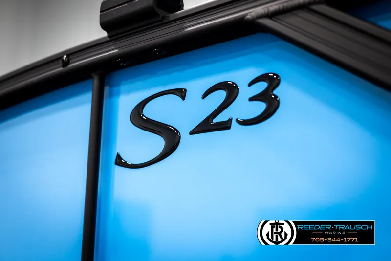 Slide: The Image of 2025 Bennington 23 SSBSE boat with "S23" emblem, blue exterior, Reeder-Trausch Marine branding. - 44