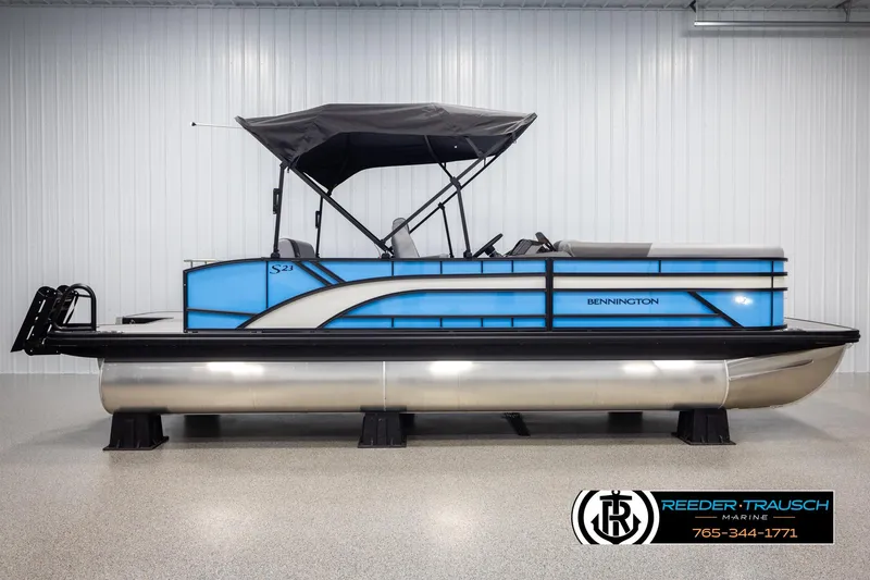 Slide: The Image of 2025 Bennington 23 SSBSE pontoon boat with canopy, displayed indoors. - 5