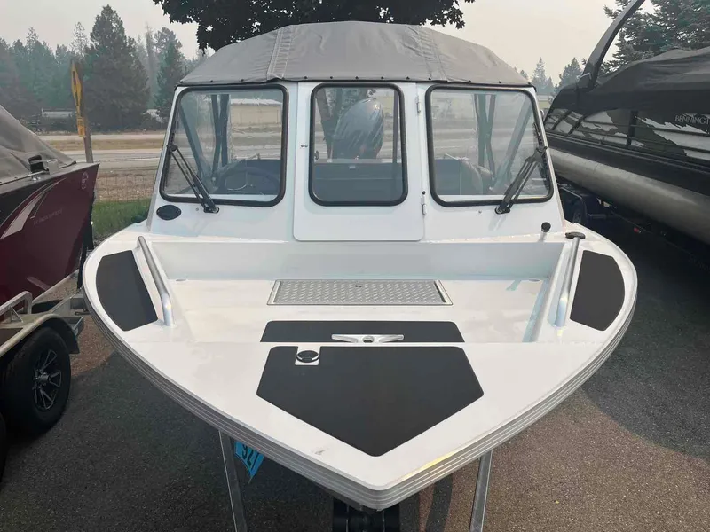Slide: The Image of 2024 Duckworth 18 ADV XT boat with canopy, parked outdoors. - 11