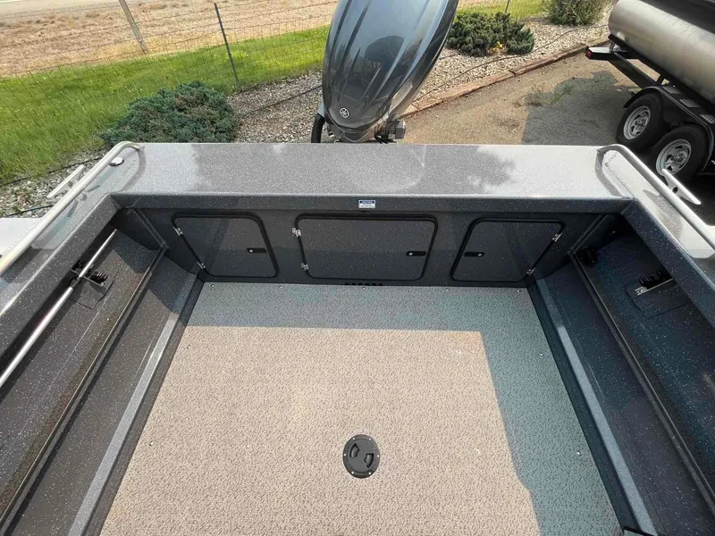 Slide: The Image of 2024 Duckworth 18 ADV XT boat interior with storage compartments and outboard motor. - 4