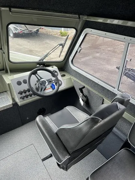 Slide: The Image of Interior of 2023 Duckworth 20 NAV SPT boat, featuring steering wheel and control panel. - 14