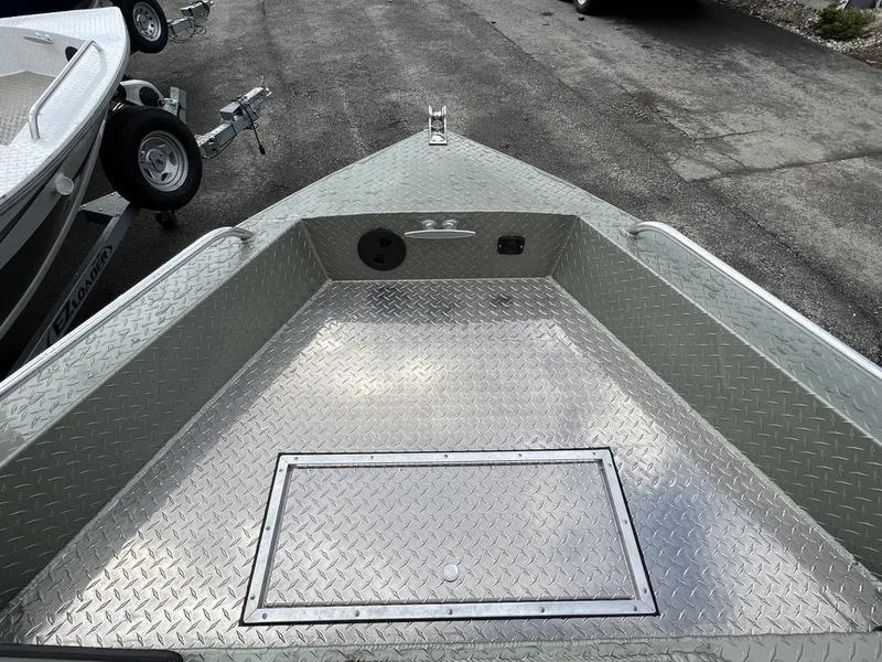 Slide: The Image of 2023 Duckworth 20 NAV SPT boat with diamond plate flooring, parked on pavement. - 16