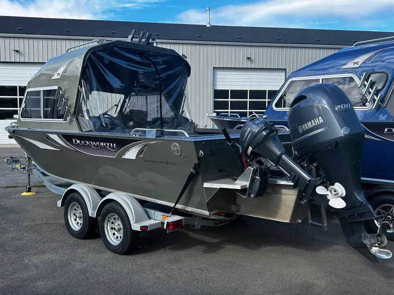 Slide: The Image of 2023 Duckworth 20 NAV SPT boat with Yamaha motor on trailer, parked outside a building. - 19