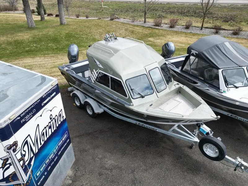 Slide: The Image of 2023 Duckworth 20 NAV SPT boat on trailer, parked near marina. - 4