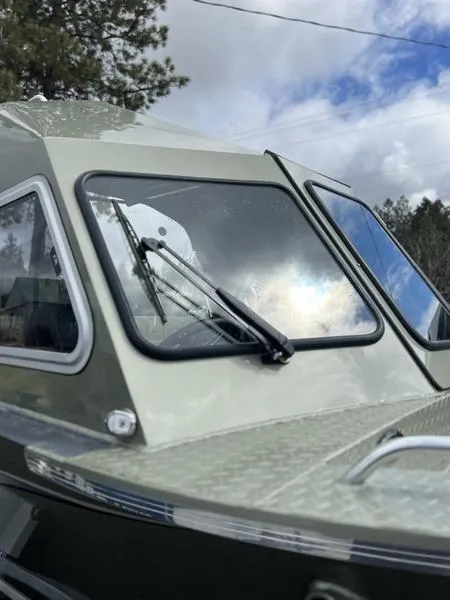 Slide: The Image of 2023 Duckworth 20 NAV SPT boat with windshield wipers, under a partly cloudy sky. - 5