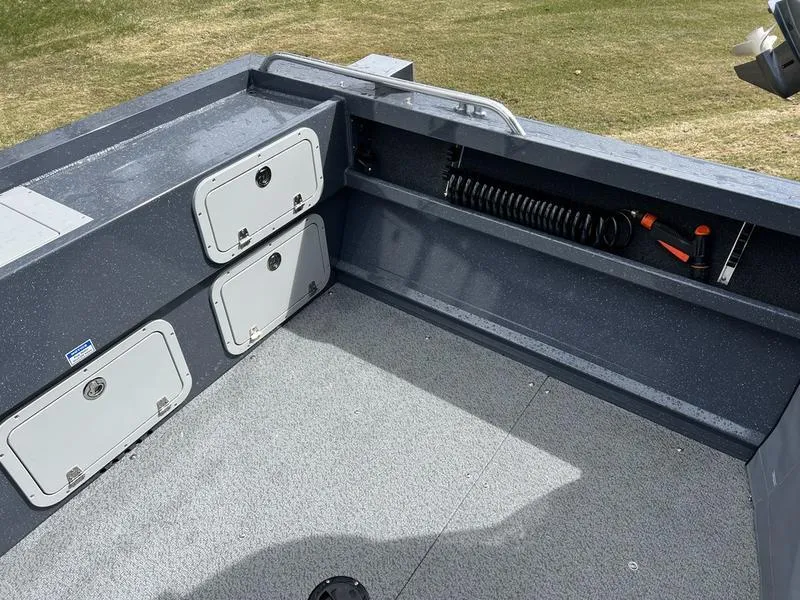 Slide: The Image of Interior of 2023 Duckworth 20 NAV SPT boat, featuring storage compartments and coiled hose. - 8