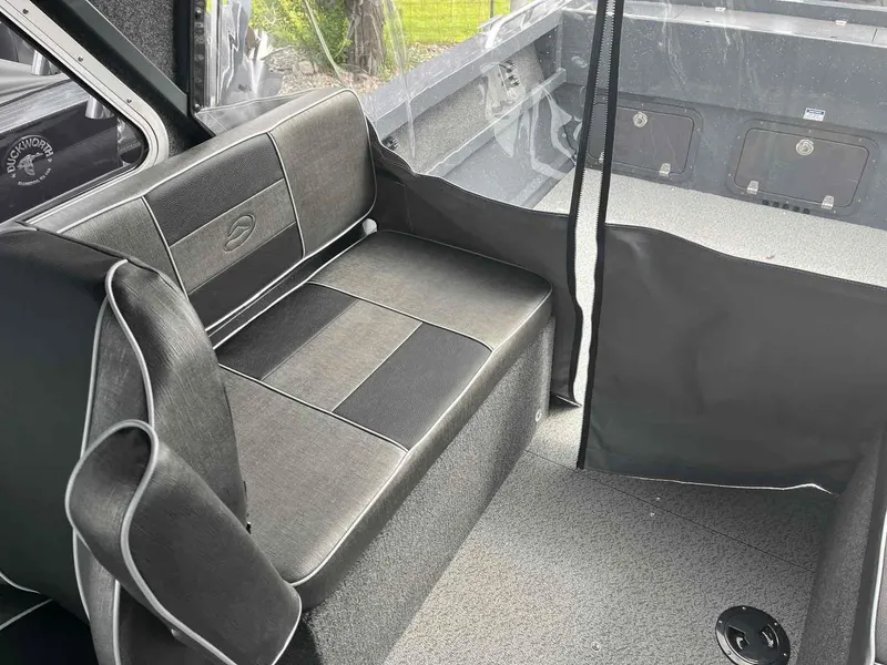 Slide: The Image of Interior of 2024 Duckworth 20 NAV SPT boat with gray seating and storage compartments. - 12