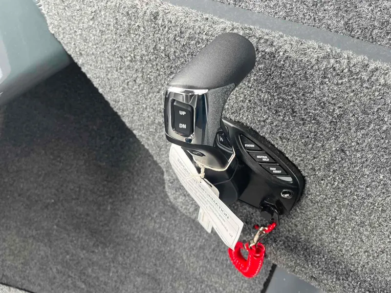 Slide: The Image of 2024 Duckworth 20 NAV SPT boat control lever with keychain and carpeted interior. - 15