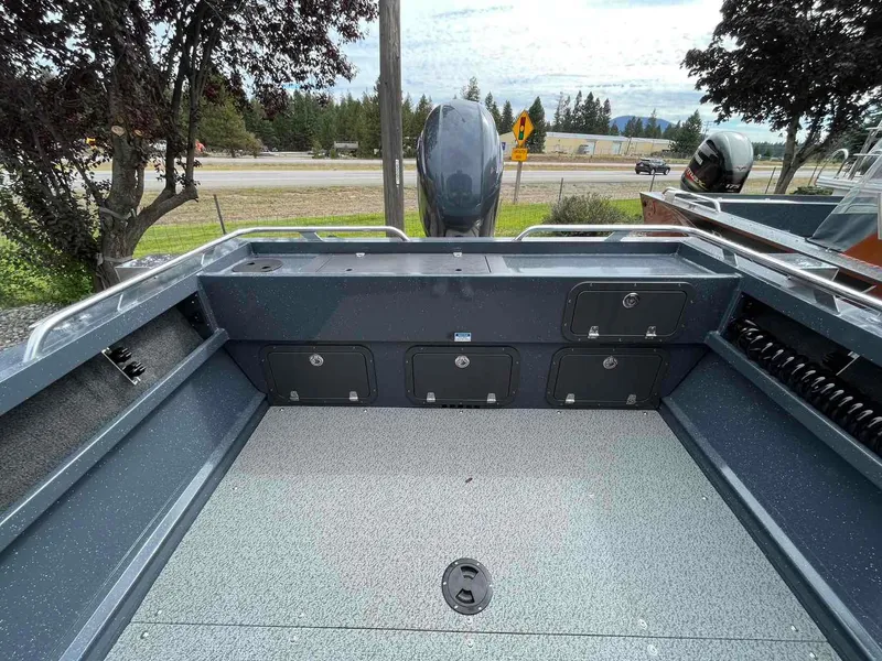 Slide: The Image of 2024 Duckworth 20 NAV SPT boat interior with storage compartments and motor view. - 6