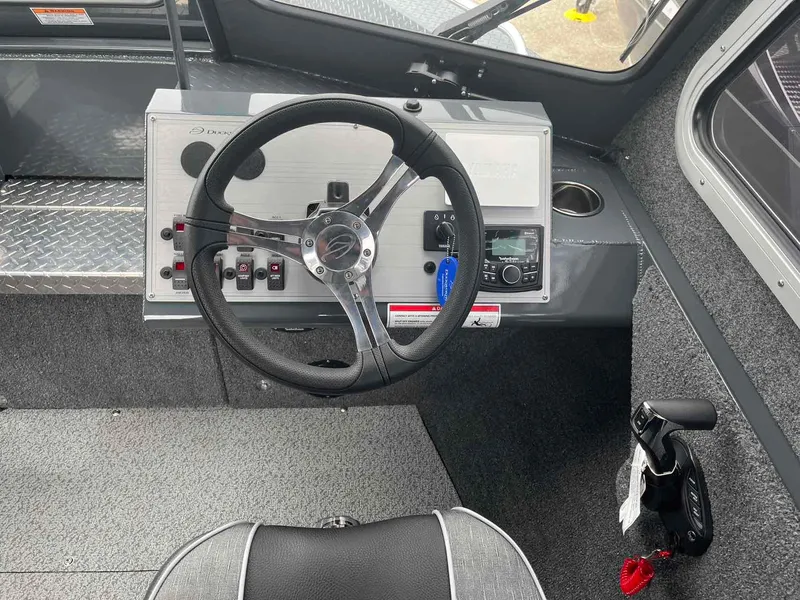 Slide: The Image of 2024 Duckworth 20 NAV SPT boat cockpit with steering wheel and control panel. - 9