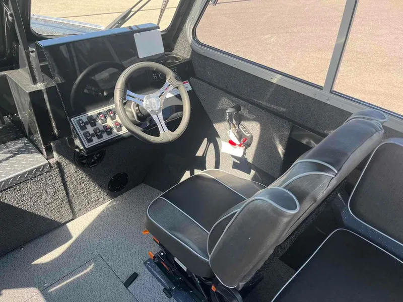 Slide: The Image of 2024 Duckworth 21 Discovery boat interior with steering wheel and control panel. - 10