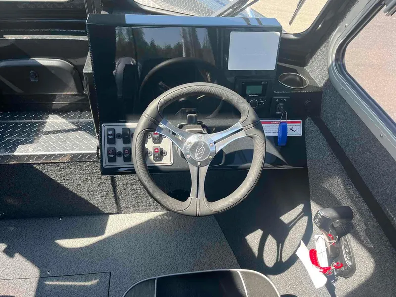 Slide: The Image of 2024 Duckworth 21 Discovery boat dashboard with steering wheel and controls. - 11