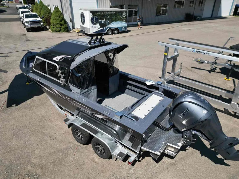 Slide: The Image of 2024 Duckworth 21 Discovery boat on trailer, featuring Yamaha outboard motor, parked outside a building. - 4
