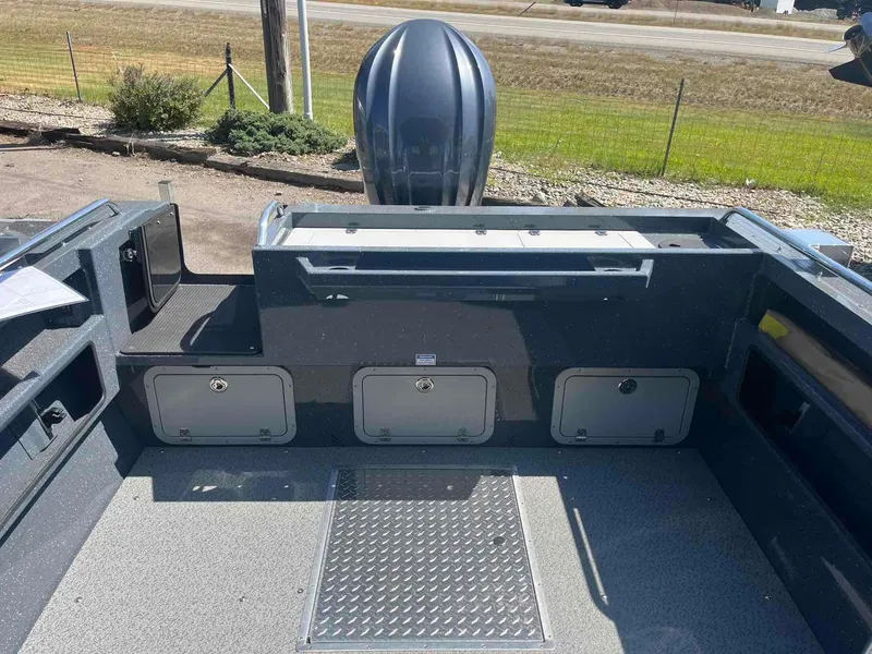 Slide: The Image of 2024 Duckworth 21 Discovery boat interior with storage compartments and motor view. - 6