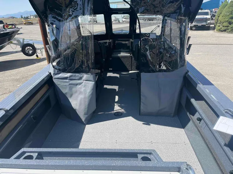 Slide: The Image of 2024 Duckworth 21 Discovery boat interior with protective covers and clear panels. - 7