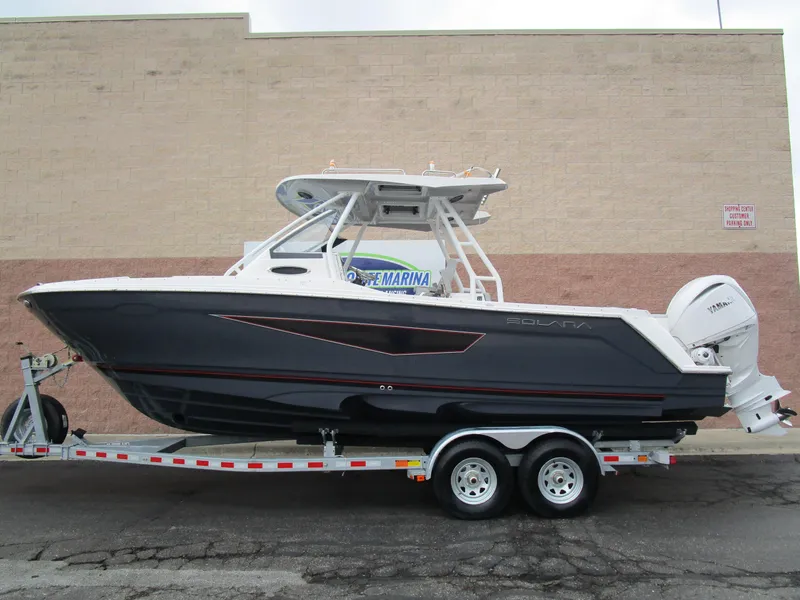 The Image of 2025 Solara S-250 CW boat on trailer, sleek design, parked outdoors. - 1