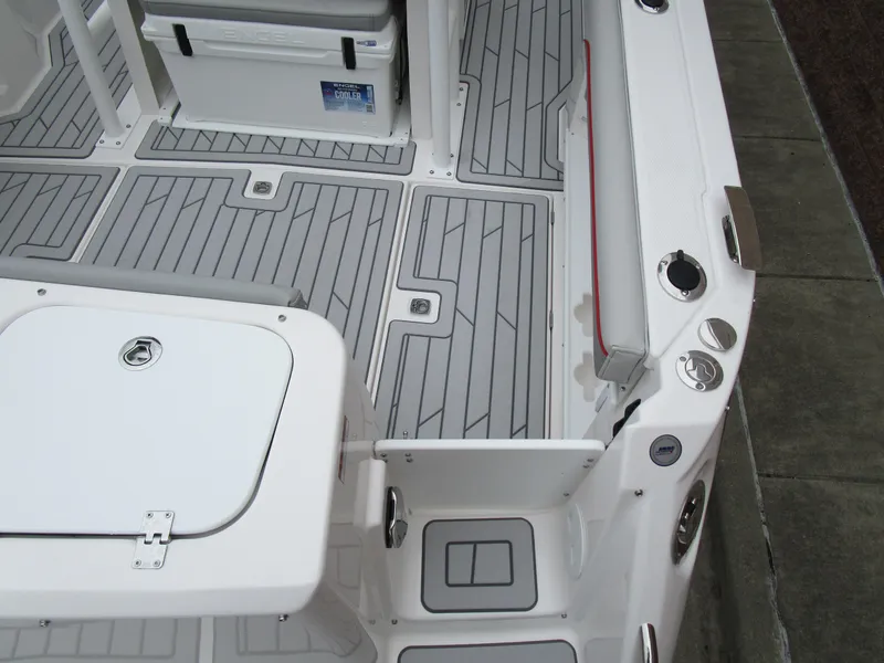 Slide: The Image of 2025 Solara S-250 CW boat deck with gray non-slip flooring and storage compartments. - 11