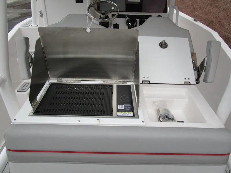 Slide: The Image of 2025 Solara S-250 CW boat interior with grill and sink setup. - 19