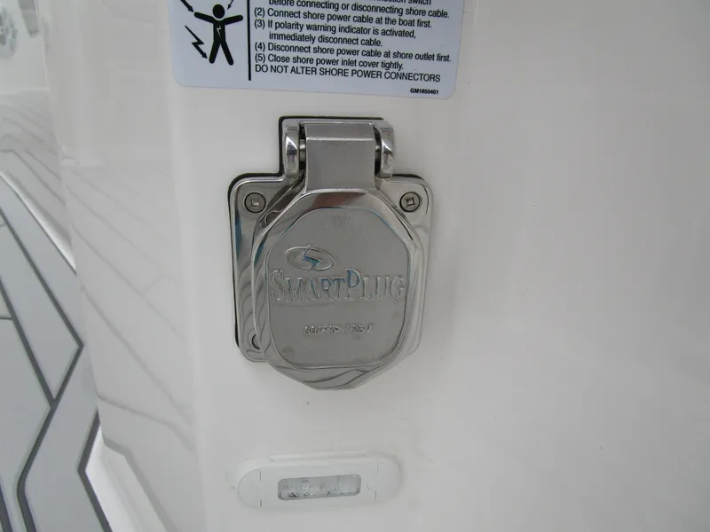 Slide: The Image of SmartPlug outlet on 2025 Solara S-250 CW boat, featuring safety instructions. - 26