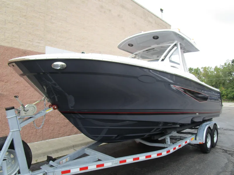 Slide: The Image of 2025 Solara S-250 CW boat on trailer, sleek design, parked outdoors. - 3
