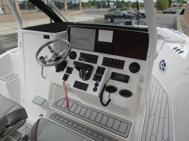 Slide: The Image of 2025 Solara S-250 CW boat cockpit with Garmin navigation system and modern controls. - 31