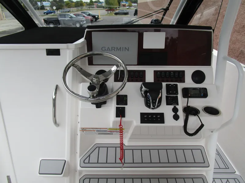 Slide: The Image of 2025 Solara S-250 CW boat helm with Garmin navigation system and modern controls. - 32