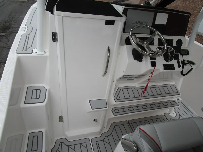 Slide: The Image of 2025 Solara S-250 CW boat cockpit with Garmin navigation system and sleek interior design. - 39