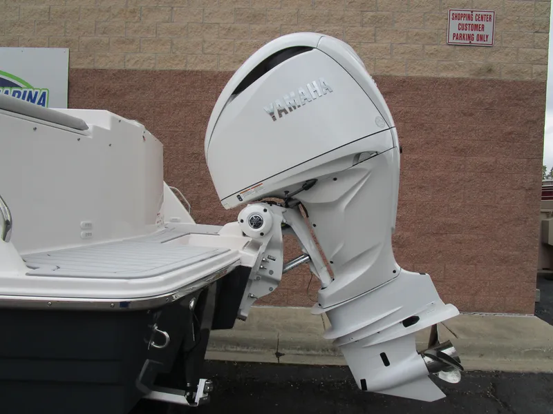 Slide: The Image of 2025 Solara S-250 CW boat with Yamaha outboard motor, docked near a brick wall. - 6