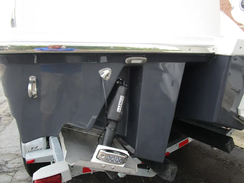 Slide: The Image of 2025 Solara S-250 CW boat stern on trailer, featuring trim tabs and hydraulic system. - 8