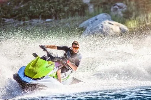 Slide: The Image of Man riding 2023 Kawasaki Jetski STX 160 on a lake, creating a splash. - 10