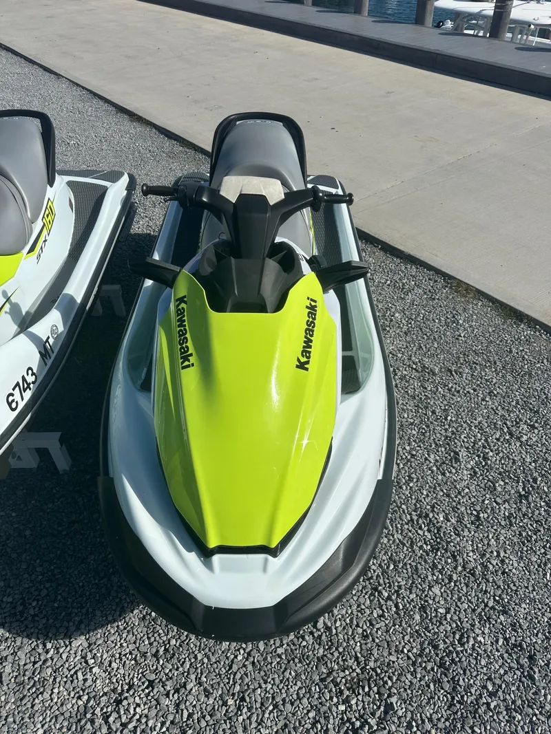 Slide: The Image of 2023 Kawasaki Jetski STX 160 in bright green and white on gravel surface. - 3