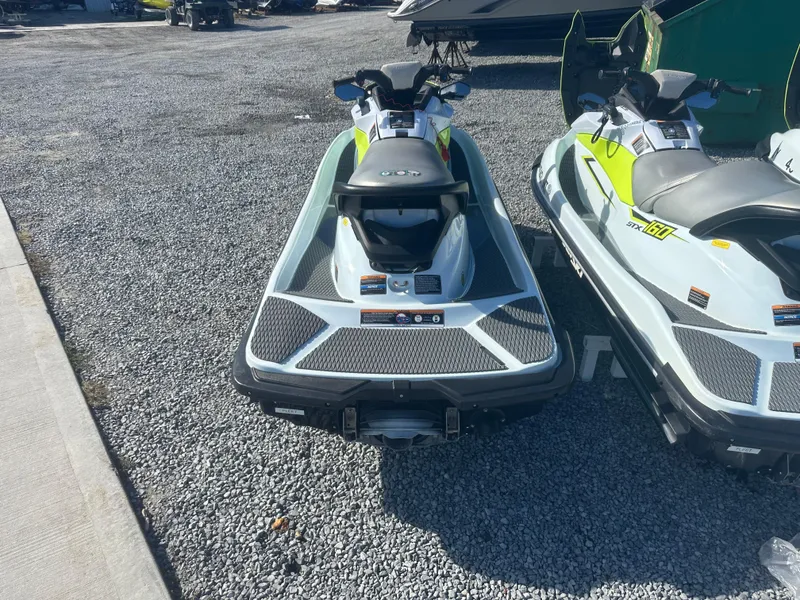 Slide: The Image of 2023 Kawasaki Jetski STX 160 on gravel lot, rear view. - 4