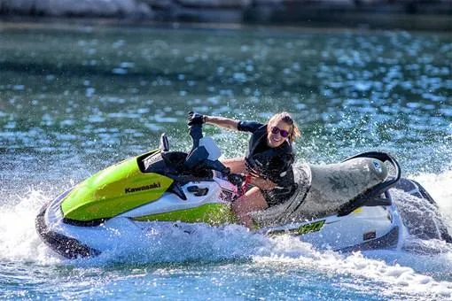 Slide: The Image of Person riding 2023 Kawasaki Jetski STX 160 on water, creating splashes. - 8