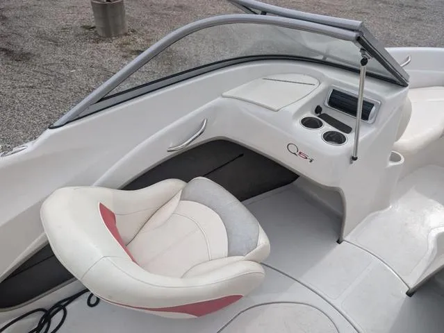 Slide: The Image of 2010 Tahoe Q5i boat interior with white and red seating, dashboard, and cup holders. - 12