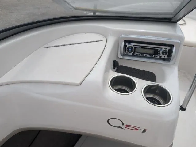 Slide: The Image of Tahoe Q5i 2010 boat dashboard with stereo and cup holders. - 13