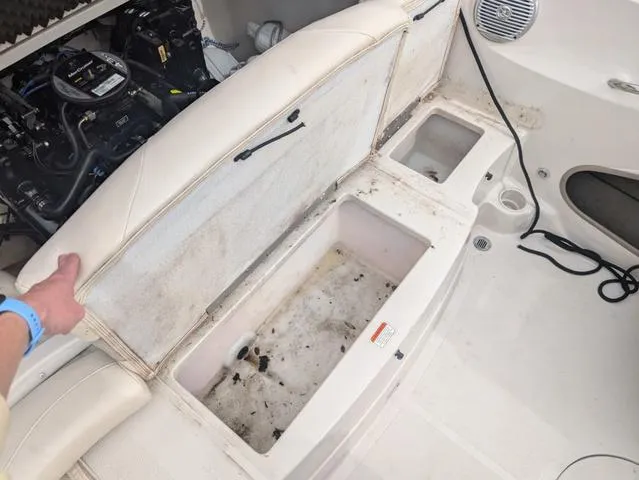 Slide: The Image of Open storage compartment in a 2010 Tahoe Q5i boat, showing engine and seating area. - 16