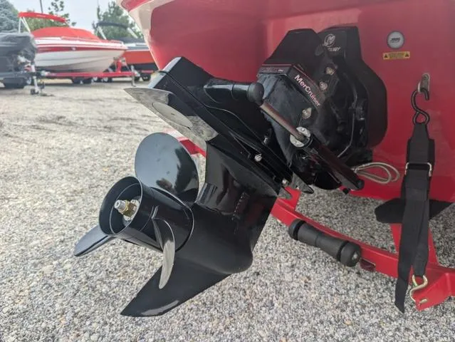 Slide: The Image of 2010 Tahoe Q5i boat with MerCruiser outdrive and propeller, parked on gravel. - 20