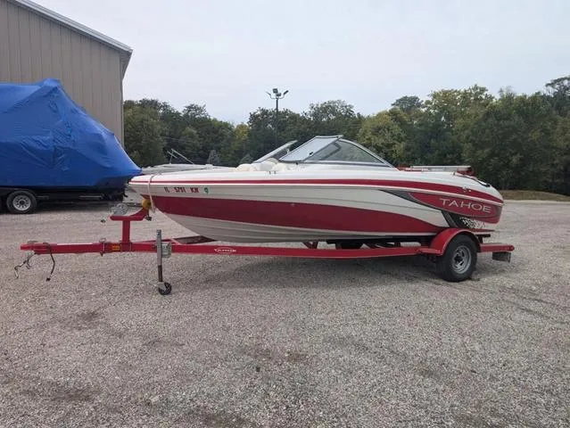 Slide: The Image of 2010 Tahoe Q5i boat on red trailer in parking lot. - 3