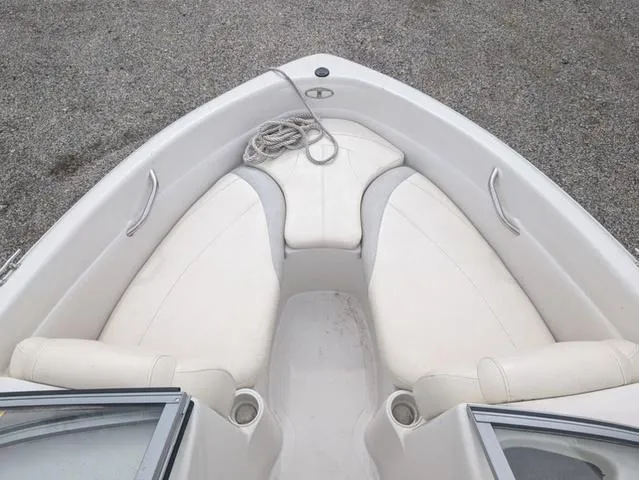 Slide: The Image of 2010 Tahoe Q5i boat interior with white seating and rope on deck. - 8