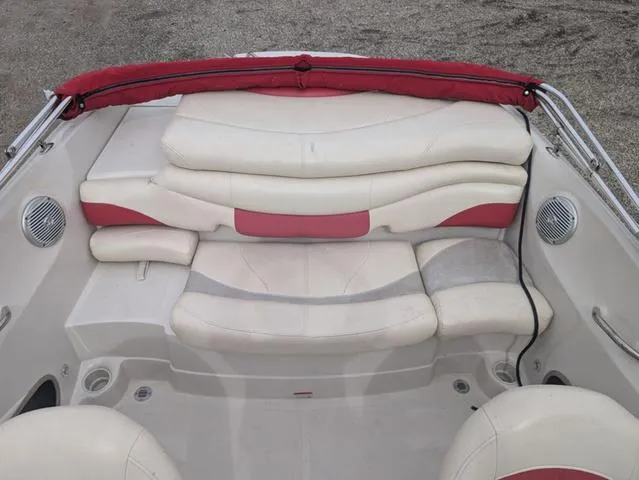 Slide: The Image of 2010 Tahoe Q5i boat interior with white and red seating, speakers, and cup holders. - 9