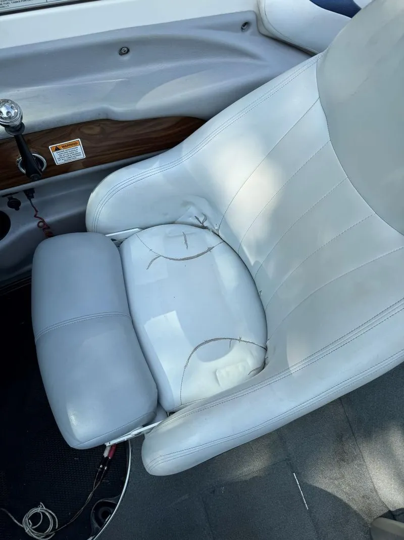 Slide: The Image of 2003 MasterCraft ProStar 197 boat seat with visible wear and tear. - 11