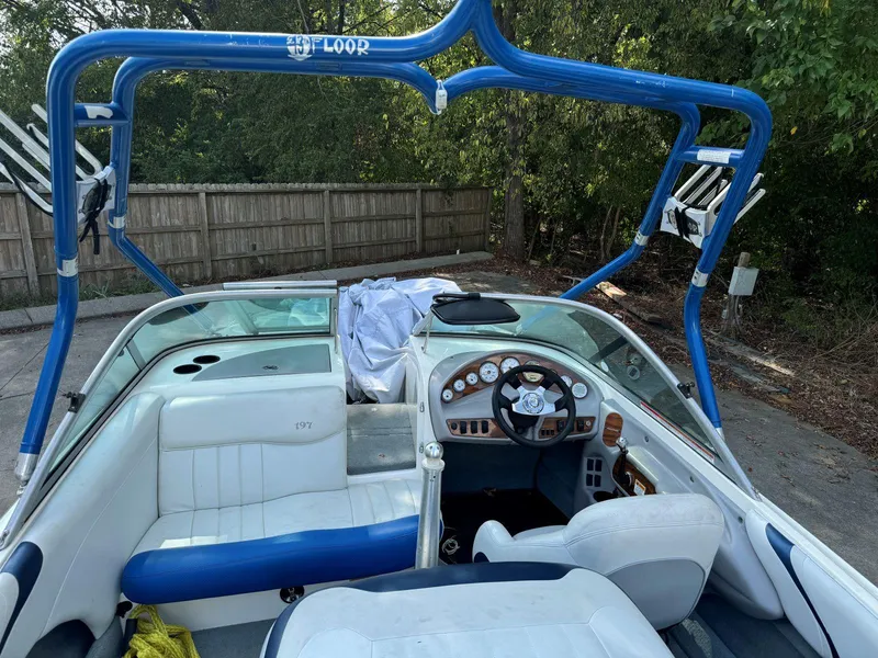 Slide: The Image of 2003 MasterCraft ProStar 197 boat interior with blue accents and steering wheel. - 16