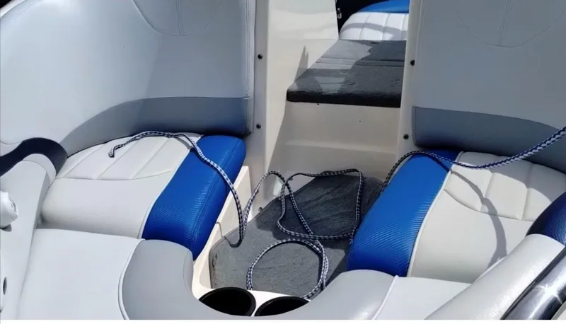 Slide: The Image of 2003 MasterCraft ProStar 197 interior with blue and white seating and ropes. - 2