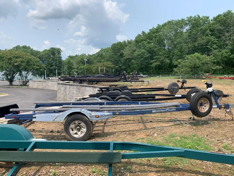 Slide: The Image of Boat trailers parked outdoors, featuring a 2003 MasterCraft ProStar 197 trailer. - 27
