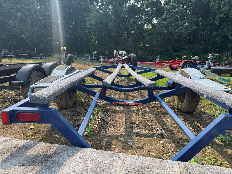 Slide: The Image of Blue boat trailer for 2003 MasterCraft ProStar 197, parked outdoors. - 28