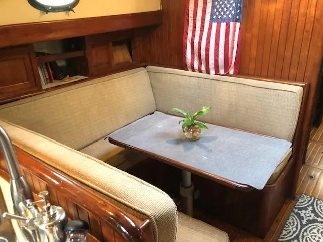 Slide: The Image of Cozy dining area in 1979 Hans Christian 38 MKII sailboat with American flag decor. - 13