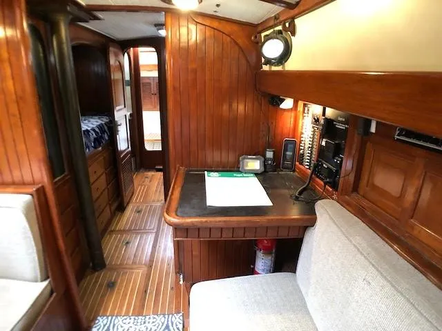 Slide: The Image of 1979 Hans Christian 38 MKII yacht interior with wooden paneling and navigation desk. - 15