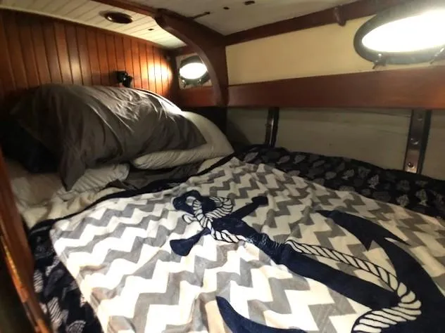 Slide: The Image of Cozy cabin interior of 1979 Hans Christian 38 MKII with nautical-themed bedding. - 16