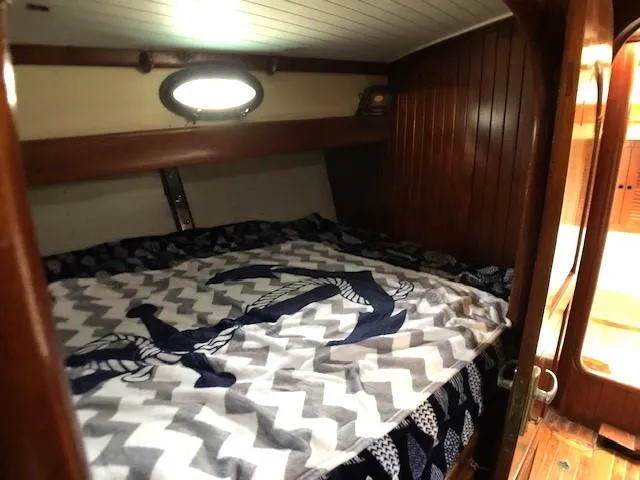 Slide: The Image of Cozy cabin interior of 1979 Hans Christian 38 MKII sailboat with nautical-themed bedding. - 17